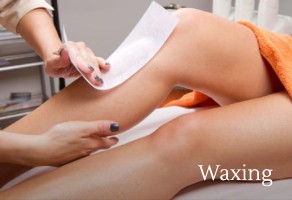 Woman getting waxing done on her legs